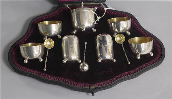 A cased late Victorian silver seven piece condiment set with three matching spoons, London, 1893/4.